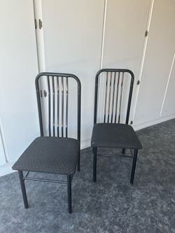 Two decorative black chairs