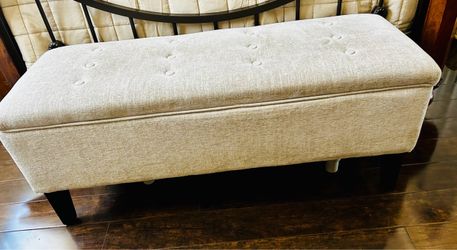 Beige upholstered storage bench