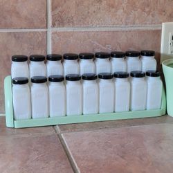 Vintage Set of 18 Griffiths' Milk Glass Spice Jars with Black Lids and Wood Stand. Great Condition 
