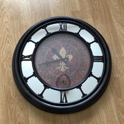 Round wall clock with Roman numerals and fleur-de-lis design. 22" Round, Use AA battery
