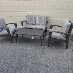 Outdoor patio wicker couch with chairs and coffee table