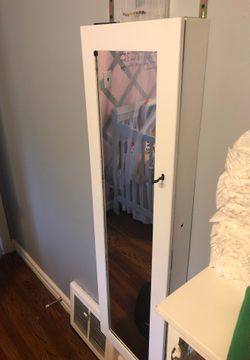 Wall Mirror and jewelry holder behind mirror with lock and key