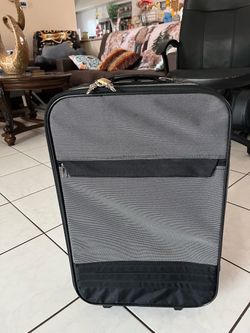 Carry-on suitcase in good condition; it measures 21 1/2 inches high, 13 inches long, and 7 inches wide