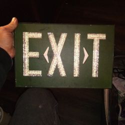GLOWING GREEN HIGH END EXIT SIGN