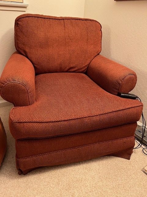 Two Rust Upholstered Swivel Chairs