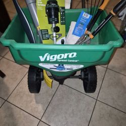 This is a Vigoro broadcast spreader with integrated spread control for lawn care. 
