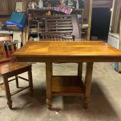 Wood table with 4 chairs. Bar height also has a leaf