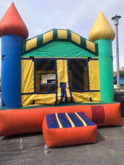 Inflatable jump house with motor