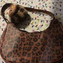 cheetah print bag with hello kitty charm