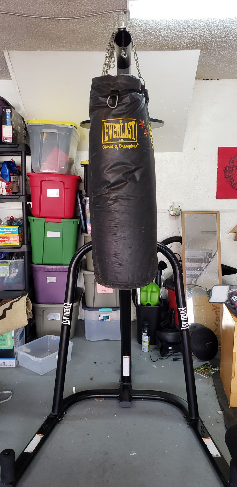 Punching bag stand, bag, and gloves.