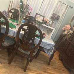 Table with 6 chairs, china cabinet, and a side cabinet with mirror and decorations