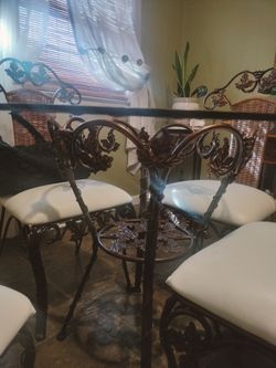 Glass top dining room table with four chairs