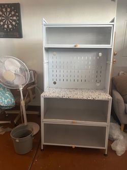 A white gabinet for a kitchen storage