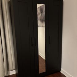 Stylish black wardrobe closet with mirror