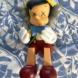Pinocchio Kaws Sitting Down 