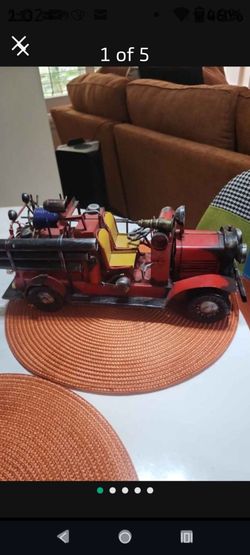 This is a handcrafted vintage-style metal fire truck collectible model.