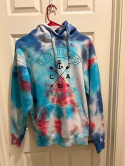 Tie-dye pullover hoodie in blue, pink, and white with a San Diego California graphic on the front featuring an anchor and crossed arrows design. Front