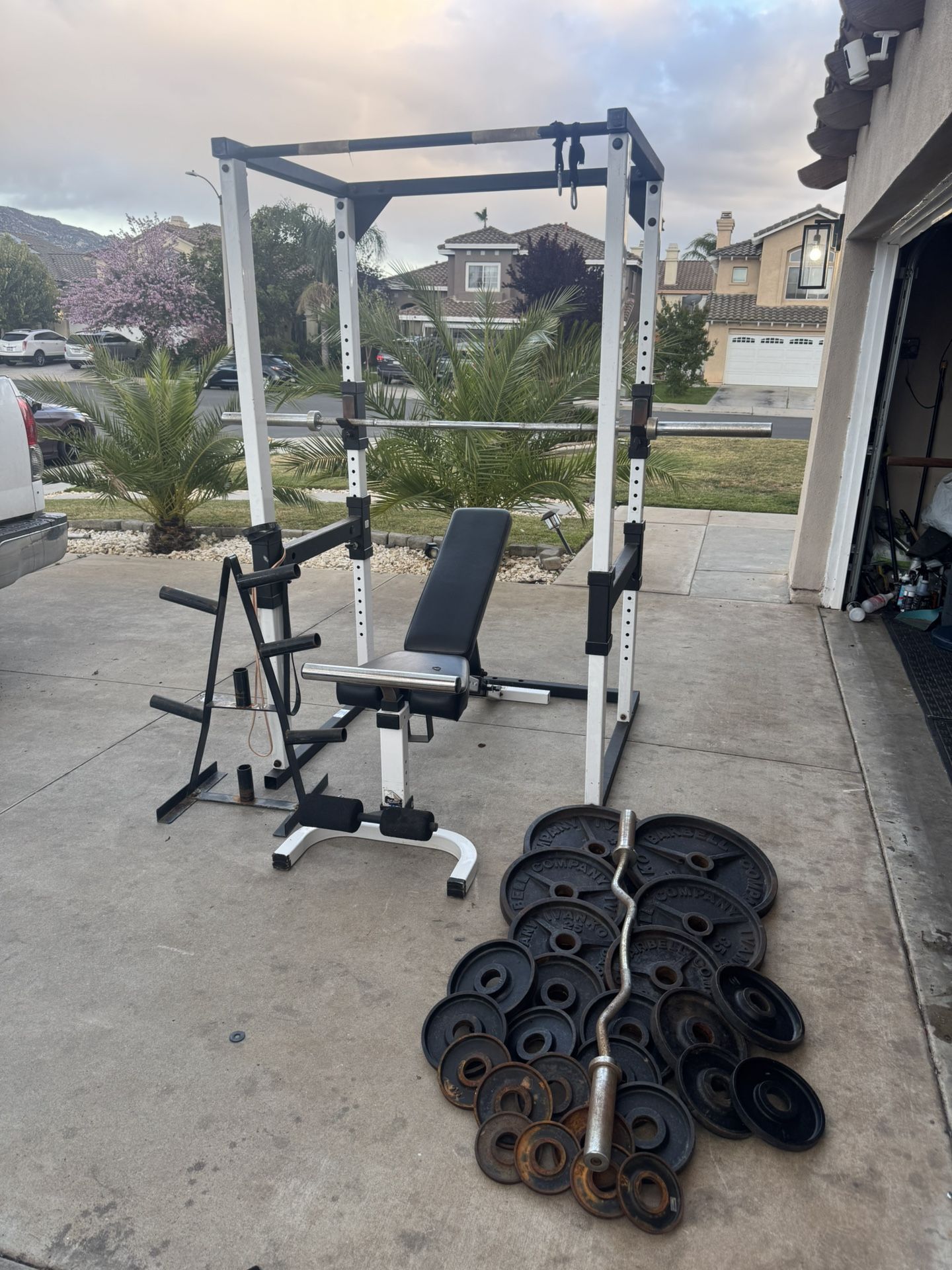 Tuff stuff commercial power cage with 7ft 45lbs bar plus 305lbs of Ivanko Olympic weights and curl bar