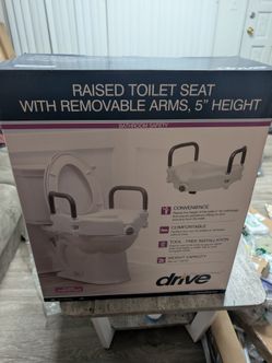 Raised toilet seat with  handles