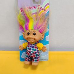Vintage 1990s Bright of America Rainbow Troll doll with multicolored hair, brown eyes, and plaid overalls.