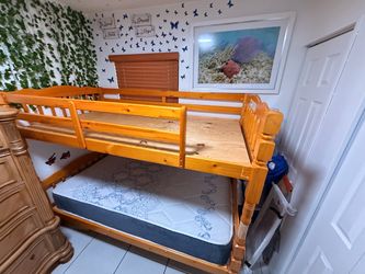Twin bunk bed with ladder and mattress