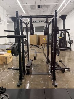 Power rack or squat cage, often a multi-functional model with various attachments