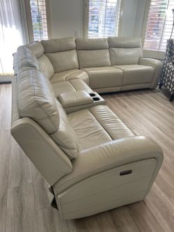 A set of leather sofas within two chairs