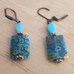 Vintage Pierced Earrings With A Blue Stone And Floral Covered Charm. 