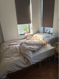 full sized mattress + wooden frame + pillows