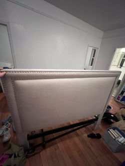 Upholstered bed board and black bed frame