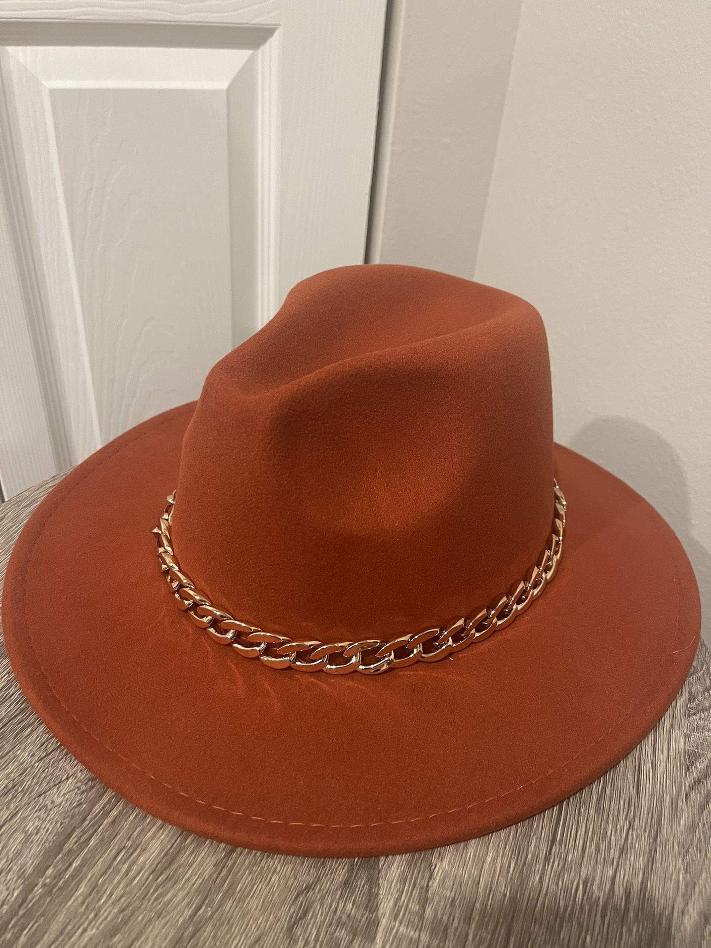 A dark Orange cowgirl Hat 