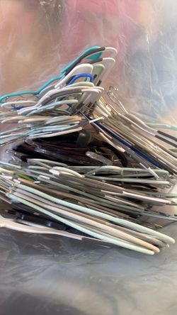Big bag of hangers some plastic and wood mixed