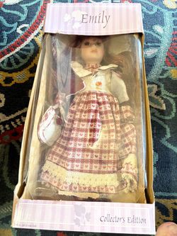 Emily-Collector’s Edition 16” porcelain faced doll with metal stand.