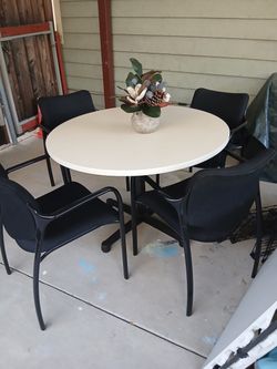 Table with 4 black chairs