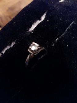 Silver solitary ring, fake diamond. Not sure on size
