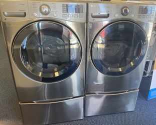 Grey LG Front Load Washing Machine and Electric Dryer Set on Pedestals (0-0047)