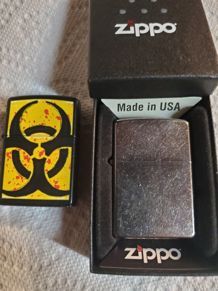 Zippo lighters, 1 new w/case , 1 used