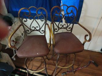 Very solid cast iron bar stools, approx.3 1/2 feet tall, no wobbling in either chair, the side to side  motion is smooth,these are not antique but mad