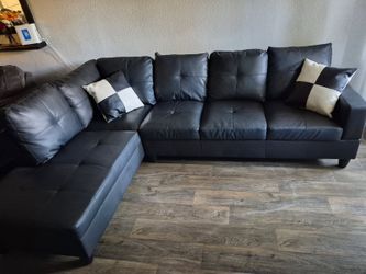 Black faux leather L-shaped sectional sofa