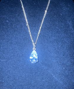 16” beaded gold necklace holding tear drop pendant