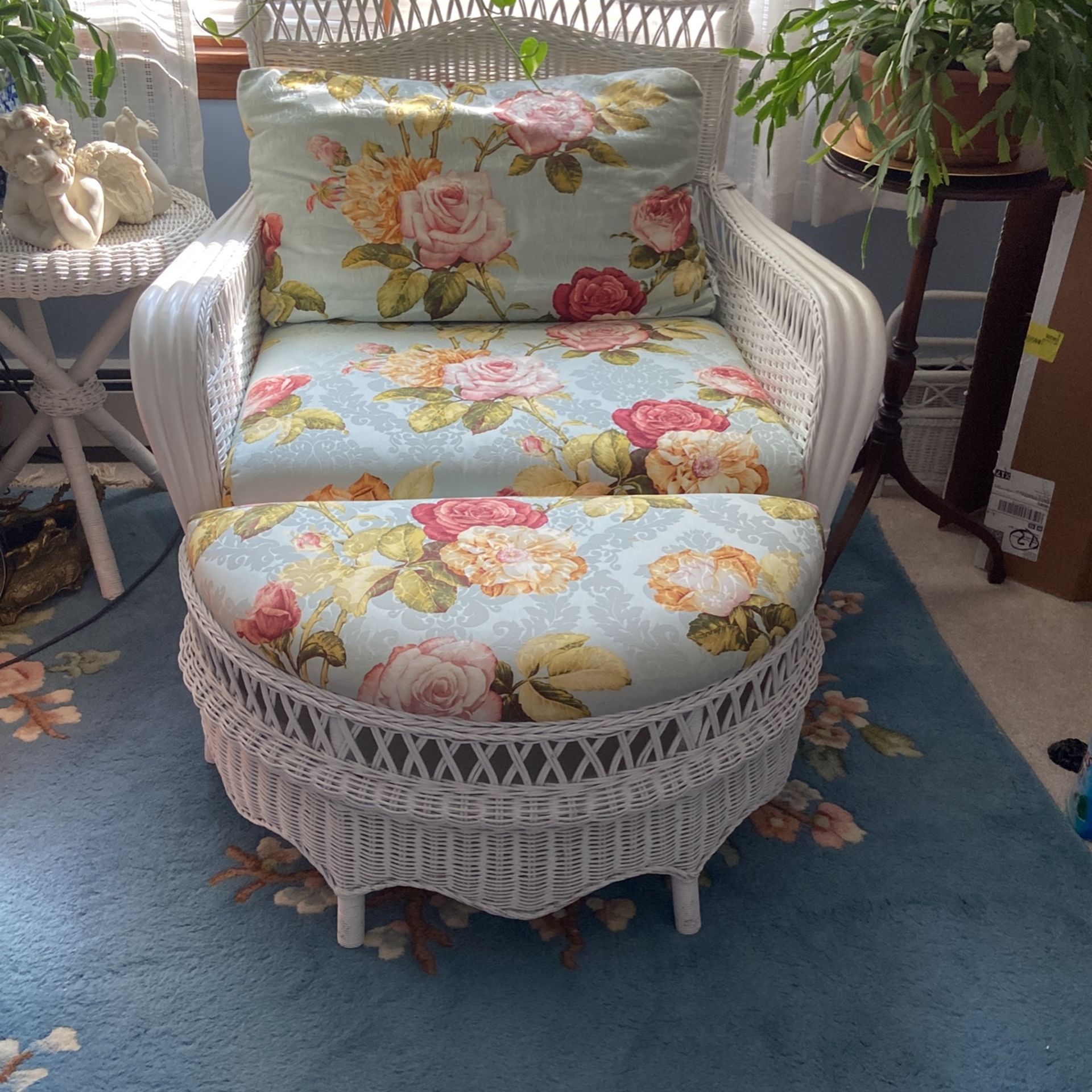 Beautiful white wicker chair and ottoman that opens for storage.
