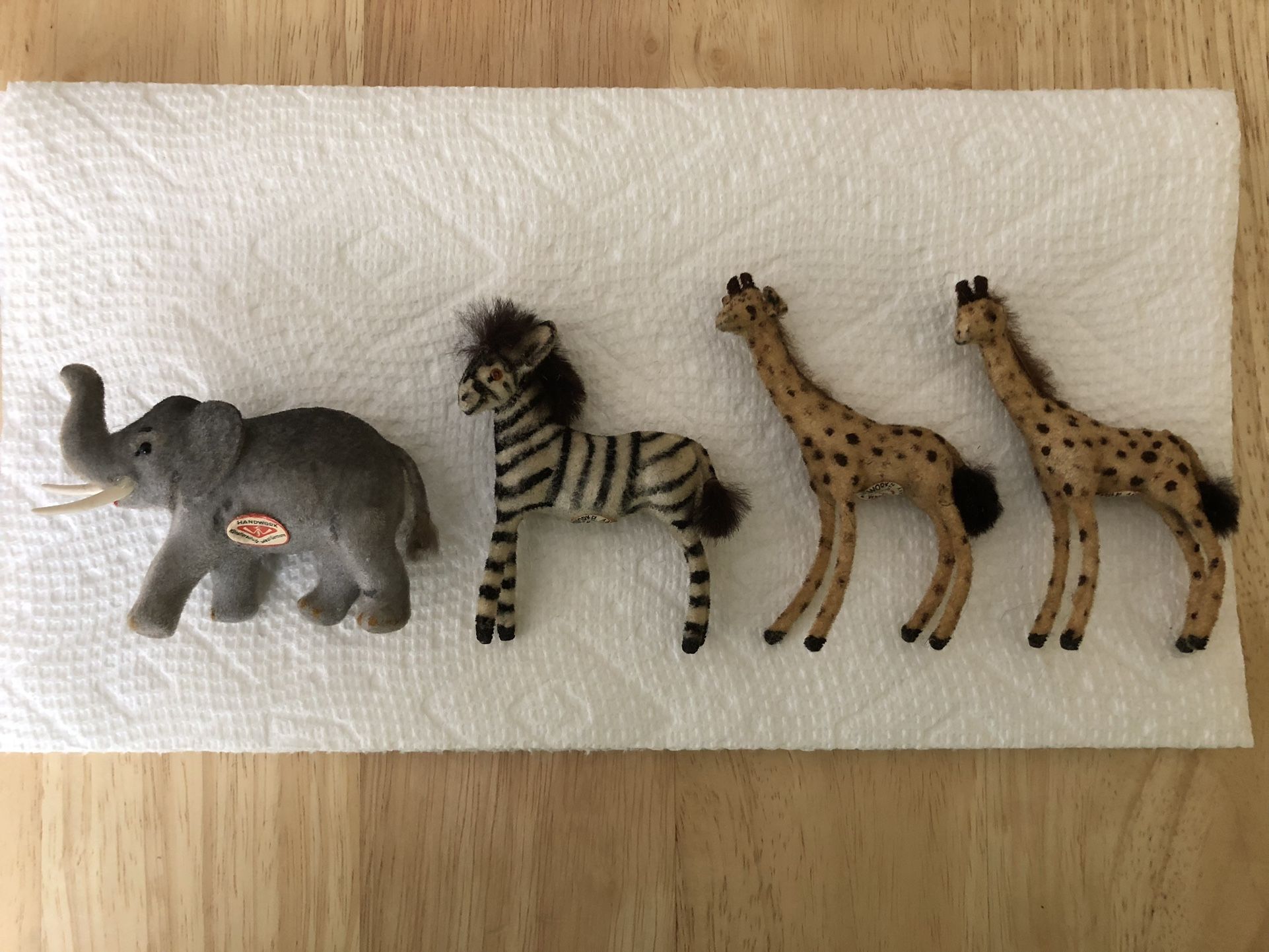 Vintage Kunstlerschutz Wagner Handwork West Germany, lot of four flocked animals, Elephant, Zebra, and two Giraffes