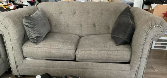 Gray Tufted Loveseat with Nailhead Trim