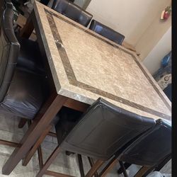 granite  marble high dining table with 8 chairs square 54" x 54" 3" feet high  good condition, the brown buttons came out of 2 chairs as seen in pic