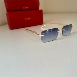 Blue Cartier sunglasses with gold frame