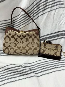 This is a vintage Coach Y2K signature brown mini shoulder bag