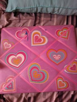 A multicolored heart picture holder for girl's room has a little bit of fingernail polish on it but still in good condition for $2