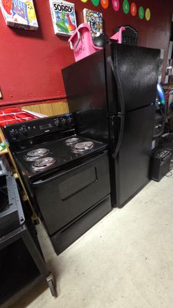 Black refrigerator and electric stove