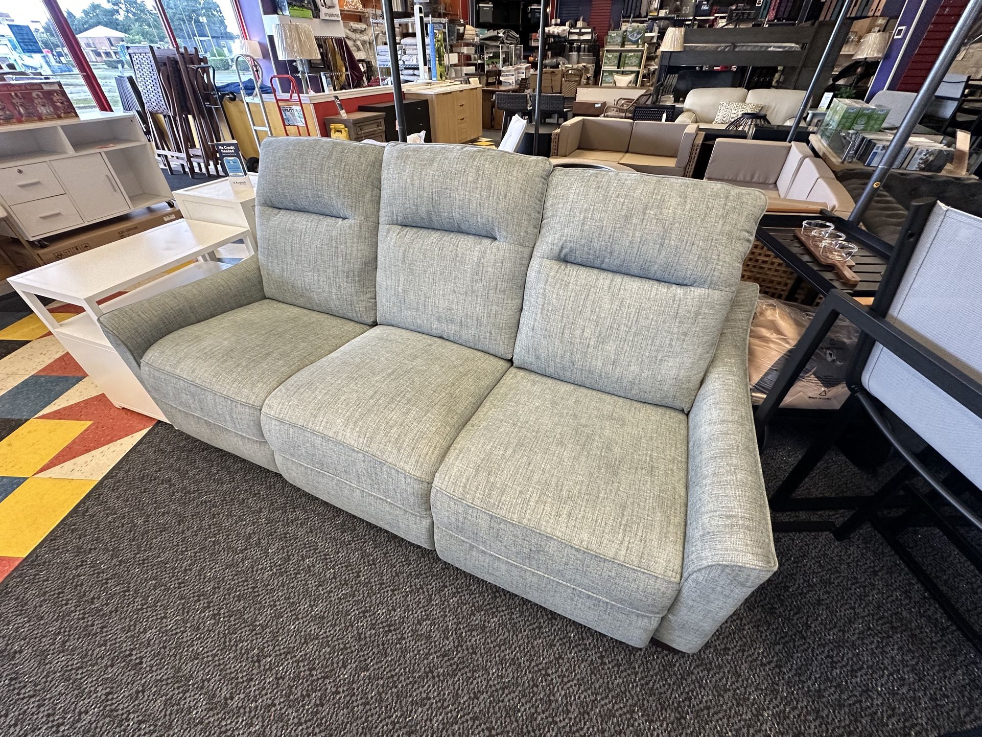 Floor model reclining sofa