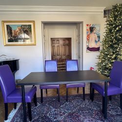 Black Table with 4 Purple Faux Leather chairs. 